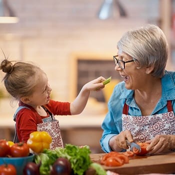 An older woman and her granddaughter cooking healthy food in Simpsonville