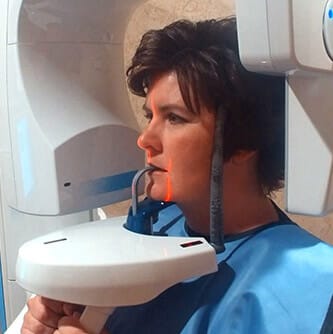 Woman receiving x-ray scan during emergency dentistry visit