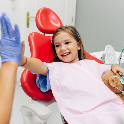 Child high-fives dentist