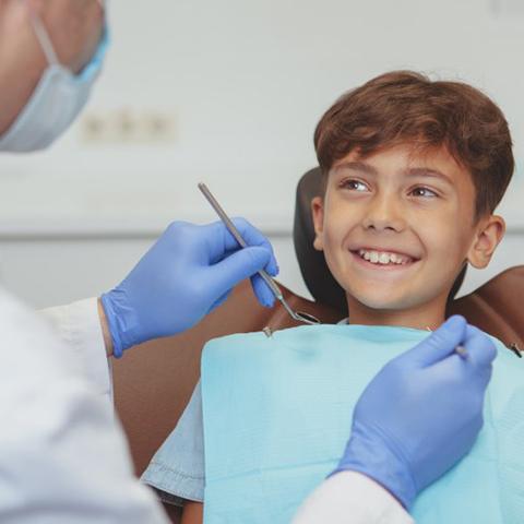 Kid smiles at dentist