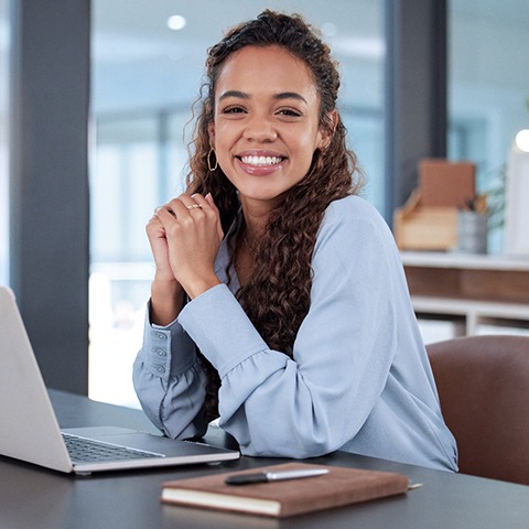 Woman smiling while sitting in office