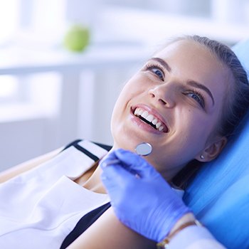 woman smiling while visiting cosmetic dentist 