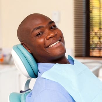 A man smiling at his next dental appointment.