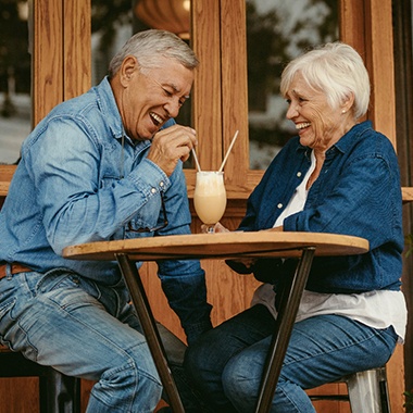 Senior couple sharing a milkshake