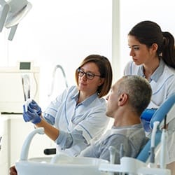 Emergency dentist reviewing findings with patient