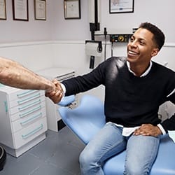 Male patient shaking hands with his dentist