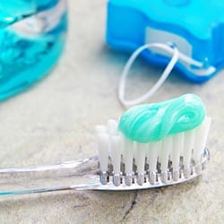 Close up of toothbrush, floss, and mouthwash