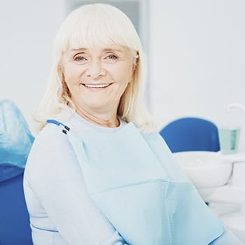 An older woman smiles after a regular dental checkup in Simpsonville