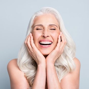 a woman joyous about her new dental implants