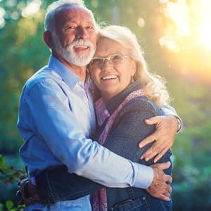 Senior couple enjoying the money-saving benefits of dental implants