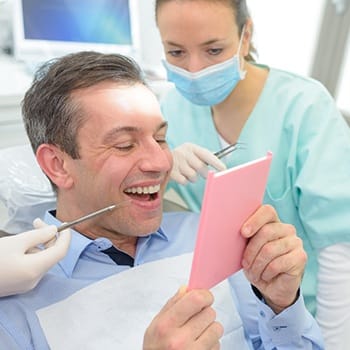 Man admiring his new dental implants in Simpsonville