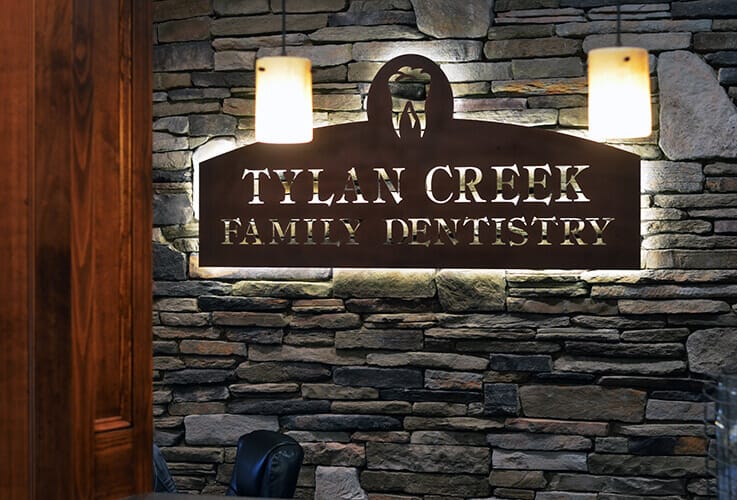 Tylan Creek Family Dentistry sign on dental office wall