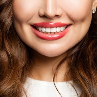 Close-up of woman’s smile with perfect teeth and glossy lips