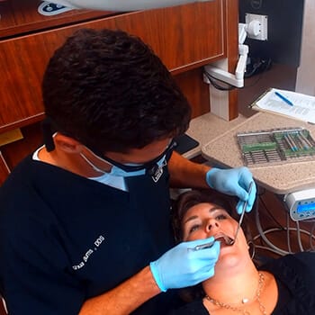 Dentist placing dental crown restoration