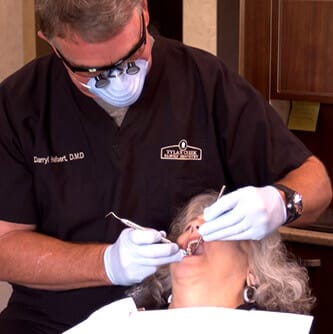 Dentist providing periodontal therapy to patient