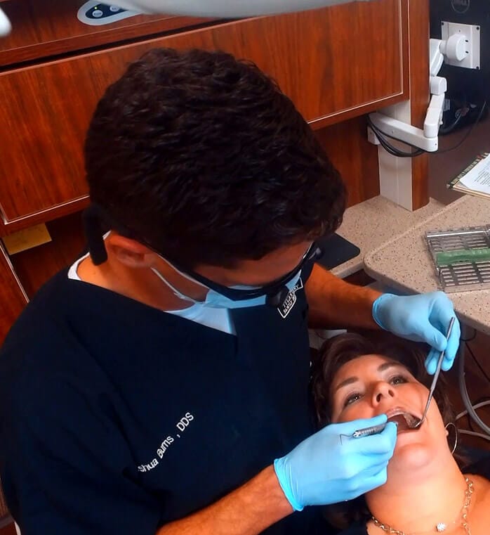Dentist performing dental exam