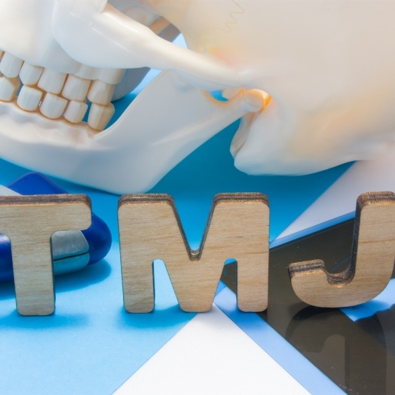 Man holding jaw in pain before TMJ treatment