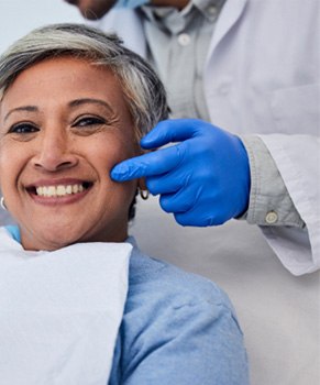 a woman smiling in a dental chair 