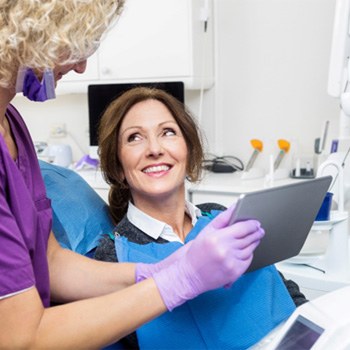 a dental hygienist speaking with a patient
