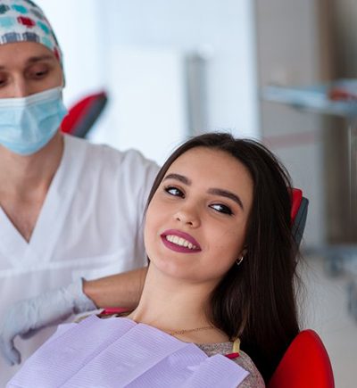 A woman about to receive teeth whitening from her dentist