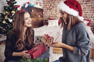 woman smiling in red santa hat