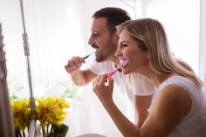 Couple brushing together.