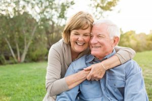 older couple smiling hugging