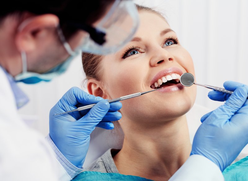 a woman receiving a dental cleaning