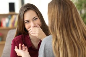 Woman covering her mouth as she smiles