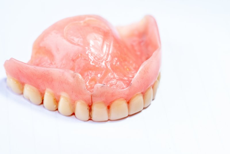 A broken denture resting on a table