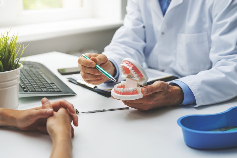 dentist discussing with patient during dental implant consultation