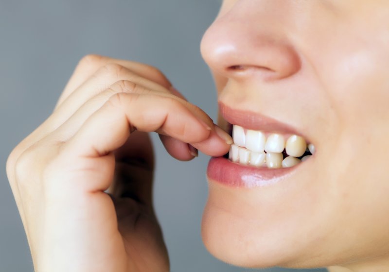 person biting their fingernails