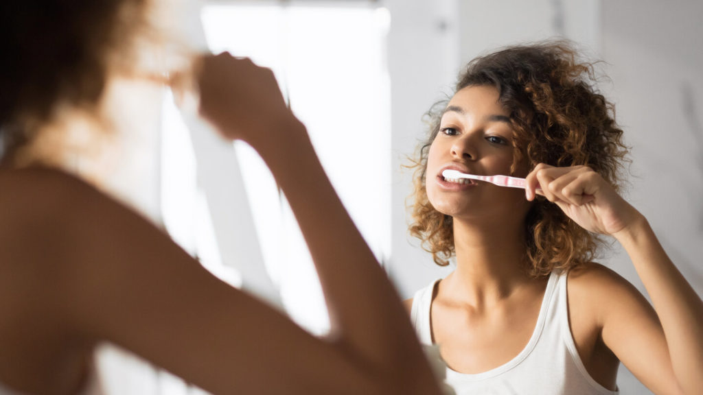 person brushing to extend the lifespan of veneers in Simpsonville