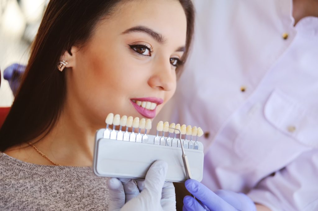 Woman smiling during veneers consultation