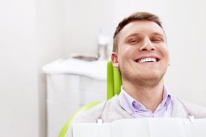 young man smiling in dental chair