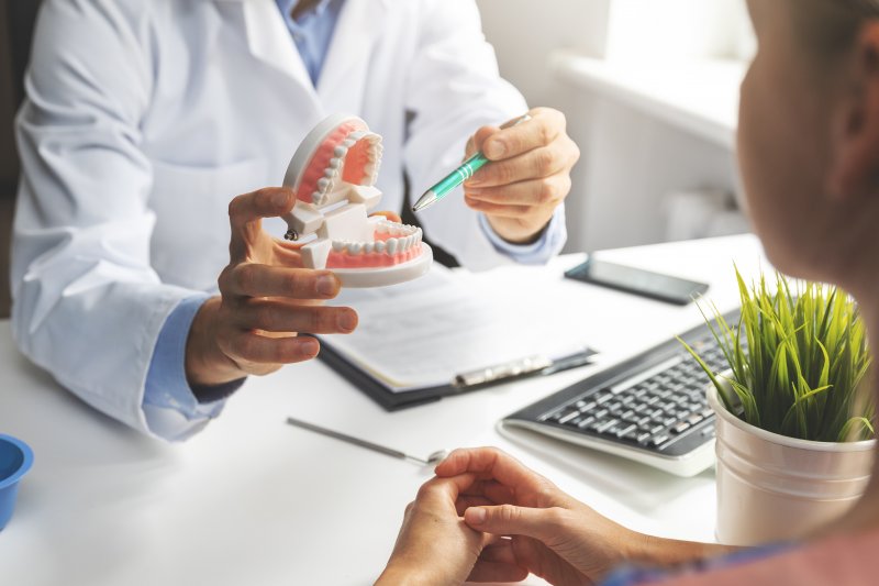 A dentist explaining tips on using denture adhesive