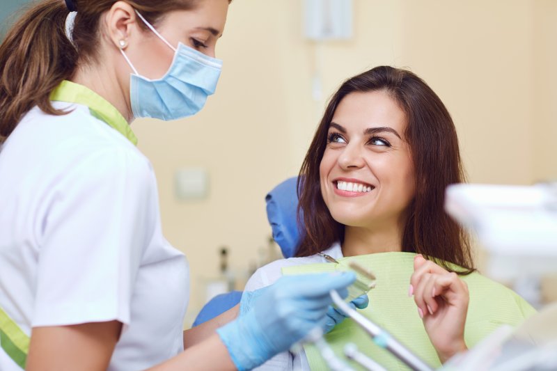 Woman smiling after having cosmetic dental issues fixed