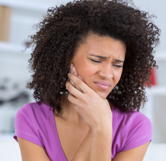 Woman holding jaw in pain
